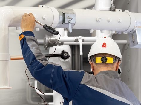 Gas detector for technical diagnostics. Locates propane leaks. Checks pipes after installation. Gas company worker ensures safety of energy infrastructure. Leak Survey for Predictive Maintenance